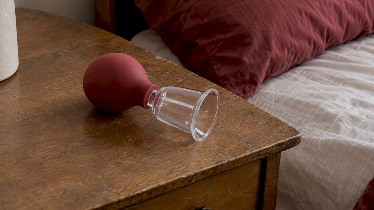 Bulb-and-cup nipple suction toy on bedside table